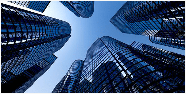 A group of tall buildings with a sky background