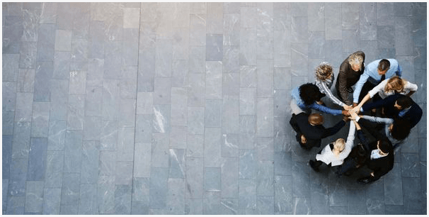 A group of people sitting on the ground.