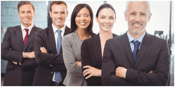 A group of people in business attire standing next to each other.