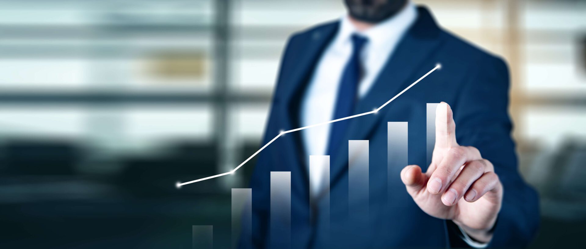 A man in a suit and tie holding a bar graph.