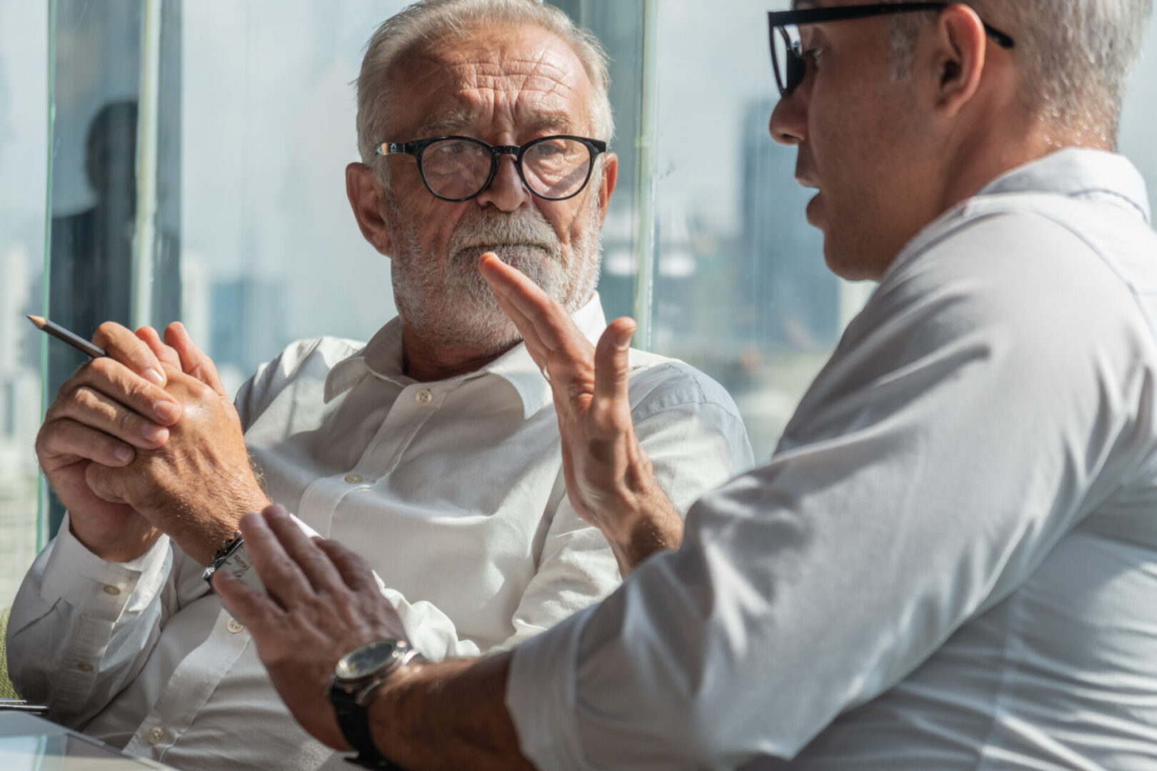 Senior,Board,Executive,Having,Business,Conversation,With,Businessman,In,Office