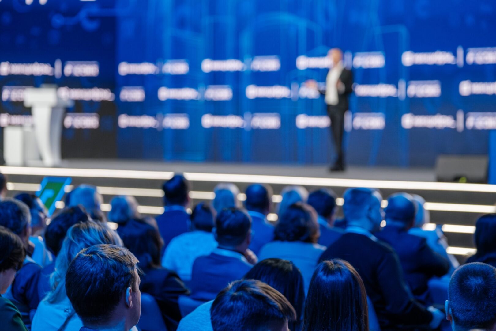 Blurred,View,Of,A,Speaker,At,A,Professional,Conference,With